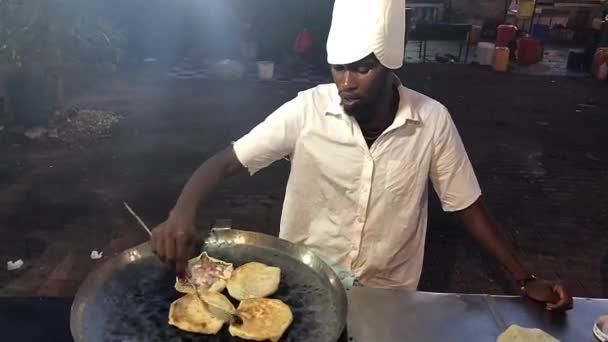 STONE TOWN, ZANZIBAR, ΦRUARI 20, 2020 - Man förbereder Zanzibar pizza på marknaden — Stockvideo