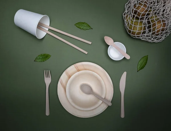 Zero waste eating utensils. Plates, cups, cutlery, and eco shopping bag. Overhead shot with copy space.