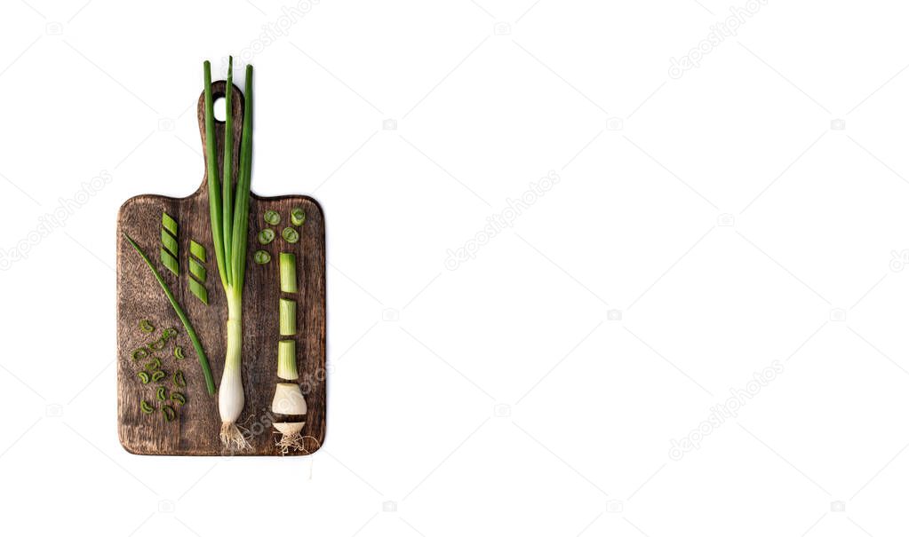 Green onion on cutting board. Knolling concept isolated on white background. Ovehead shot with copy space.