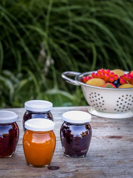 Four Jars Homemade Jam Blackberries Strawberries Apricots Wooden Table Garden — Stock Photo, Image