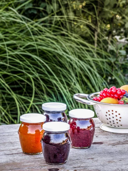 Four Jars Homemade Jam Blackberries Strawberries Apricots Wooden Table Garden — Stock Photo, Image