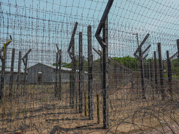 PHU QUOC, VIETNAM - March 27, 2017: Barb wire fence in Coconut Tree Prison. Close up.
