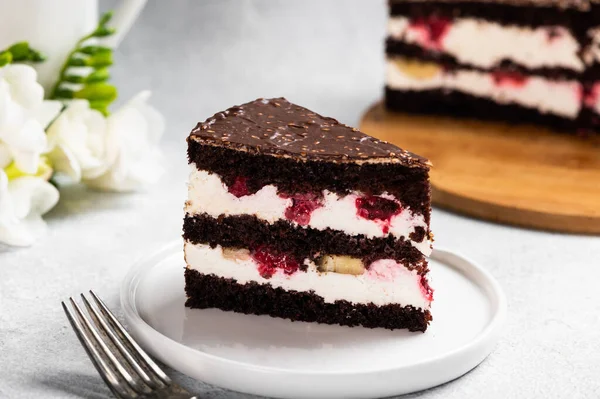 Raspberry cake with chocolate. Chocolate cake with berries. Piece of cake on a plate. Dessert on white background. Black forest cake