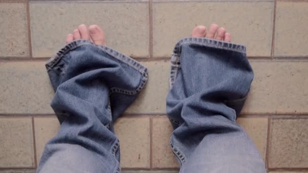 Child wearing jeans of his father — Stock Video