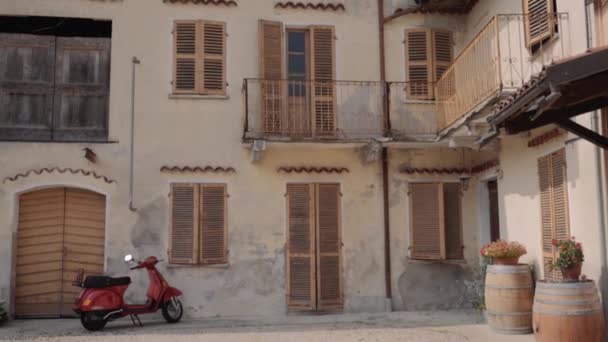 Scooter rojo estacionado en casa vieja — Vídeo de stock