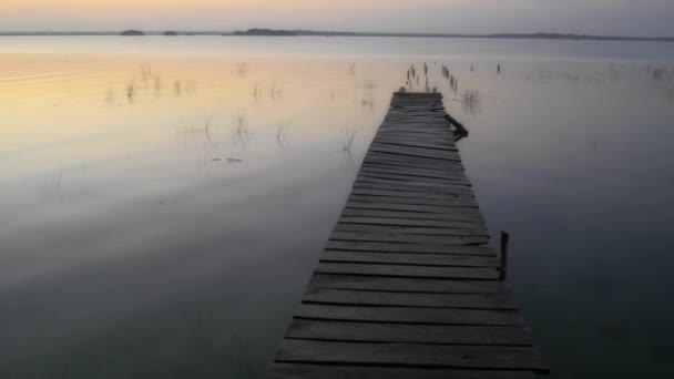 Dock at dawn in lagoon — Stock Video