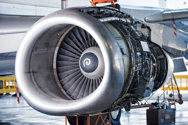 aircraft engine servicing - opened panels of a large engine of parked aircraft. nobody