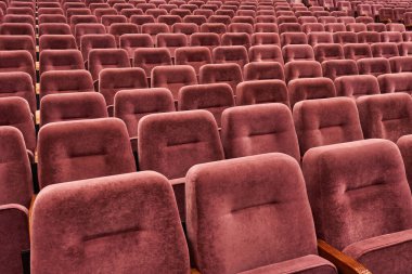 Rows of red cinema seats. View of empty theater hall. Comfort chairs in the modern theater interior. no people