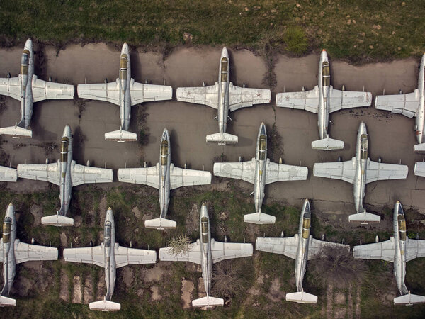 Old abandoned airfield with abandoned planes. Aerial view from a drone