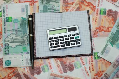 Kalem, not defteri ve Rusça bir arka plan üzerinde mon yalan hesap makinesi