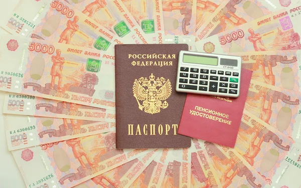Certificado de pensão, passaporte e calculadora em segundo plano o Fotos De Bancos De Imagens Sem Royalties