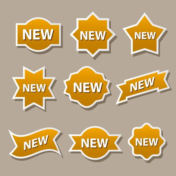 Nieuwe gouden reclame badges — Stockvector