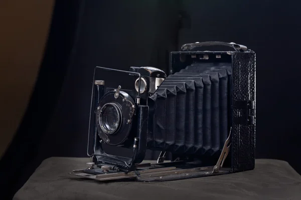 Old film camera on a dark background — Stock Photo, Image