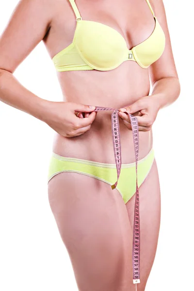 Beautiful young girl in a swimsuit measure yourself body fragmen — Stock Photo, Image