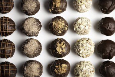 variety of handmade gourmet chocolate truffle candy on a white plate