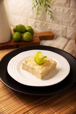 Carlota de Limon, a cold, no-bake dessert made with layers of Maria cookies and a creamy mixture of lemon and condensed milk, an easy homemade recipe very popular in Mexico.