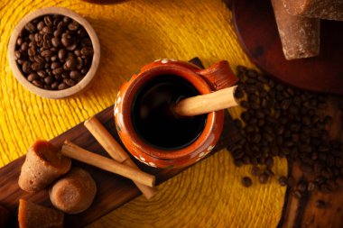 Cafe de olla, a traditional spiced Mexican black coffee, the recipe varies by region, with cinnamon, brown sugar, or piloncillo, and some recipes include cloves and star anise.