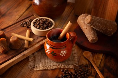 Cafe de olla, a traditional spiced Mexican black coffee, the recipe varies by region, with cinnamon, brown sugar, or piloncillo, and some recipes include cloves and star anise.