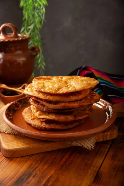 Mexican Bunuelos. Traditionally fried wheat tortillas used for Christmas and winter holidays, these are fried flour tortillas sprinkled with sugar or covered in a syrup made with piloncillo, cinnamon, and guava.