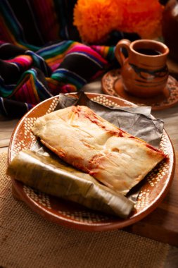 Oaxacan Tamales. A pre-Hispanic dish typical of Mexico and some Latin American countries. Corn dough wrapped in banana leaves is filled with meat or a stew. Tamales are steamed.