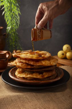 Mexican Bunuelos. Traditional food at Christmas and winter holidays in Mexico, these are fried flour tortillas sprinkled with sugar or covered in a syrup made with piloncillo, cinnamon, and guava.