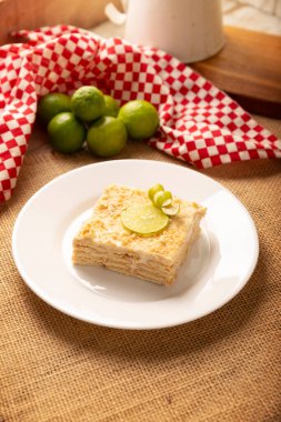 Carlota de Limon, a cold, no-bake dessert made with layers of Maria cookies and a creamy mixture of lemon and condensed milk, an easy homemade recipe very popular in Mexico.