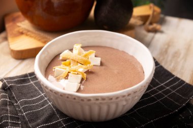Creamy bean soup. In Mexico known as Crema de Frijoles, nutritious homemade food recipe, commonly accompanied with cheese, cream, avocado and corn tortilla cut into strips and fried.