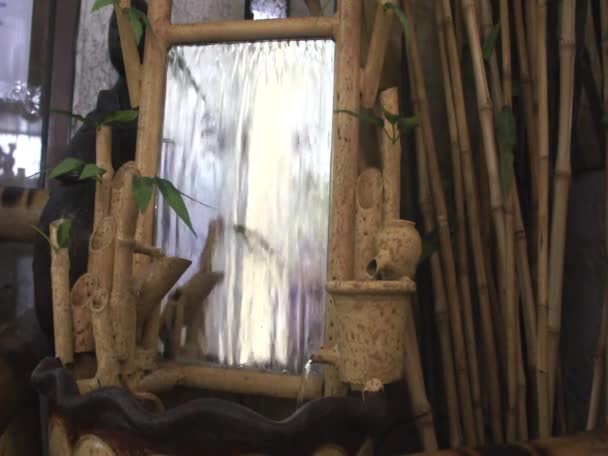 Small artificial waterfall with bamboo. journey. adventure. — Stock Video