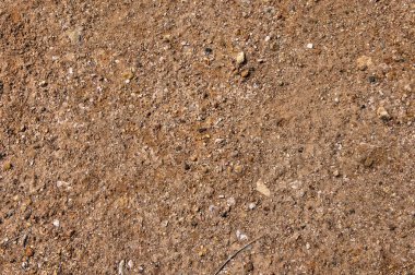 Kırmızı kil yüzey. Küçük taşlar. Soyutlama. Arka plan.