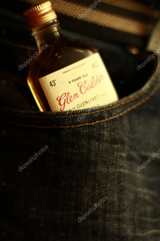 Lviv/Ukraine - 04.12.2013: Glen Calder Scotch Whisky Miniature bottle lies in a jeans pocket