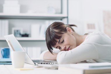 woman at office desk sleeping