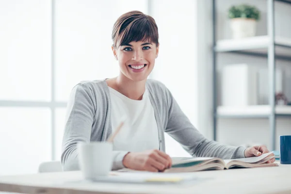 Donna sorridente che legge un libro — Foto Stock