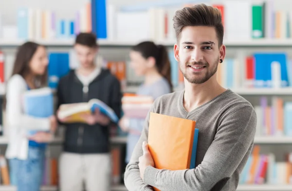 Student holding books — Stock Photo, Image