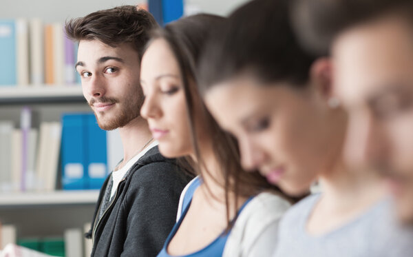 students in the library standing in line