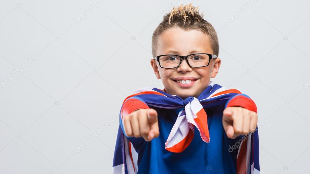 smiling superhero boy pointing
