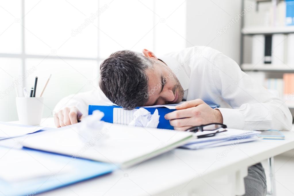 businessman sleeping on his desk