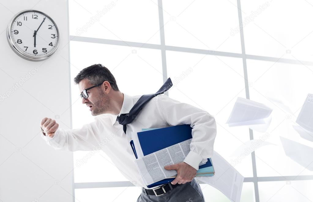 Businessman trying to stop time Stock Photo by ©kantver 69891211