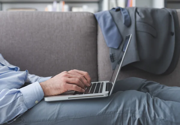 Businessman lying down and working — Stock Photo, Image