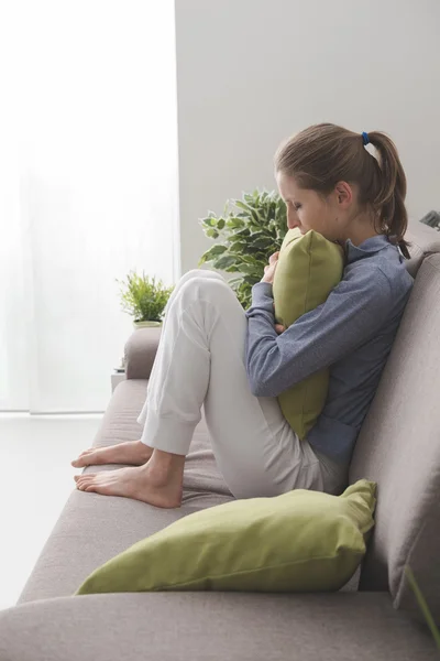 Lonely woman sitting on the sofa — Stock Photo, Image