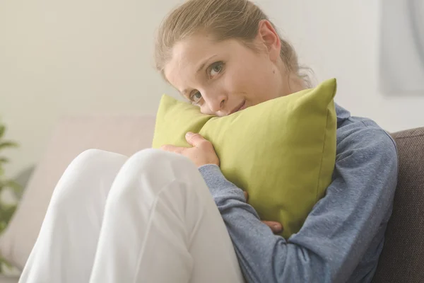 Woman hugging a pillow — Stock Photo, Image