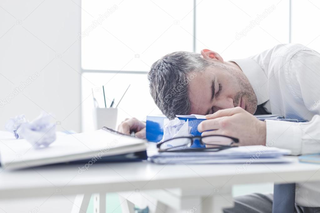 Manager sleeping on his desk