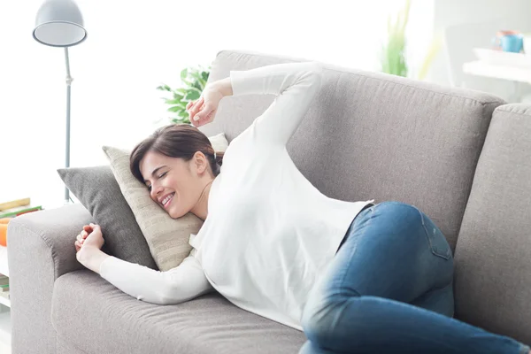 Woman stretching on the couch — Stock Photo, Image