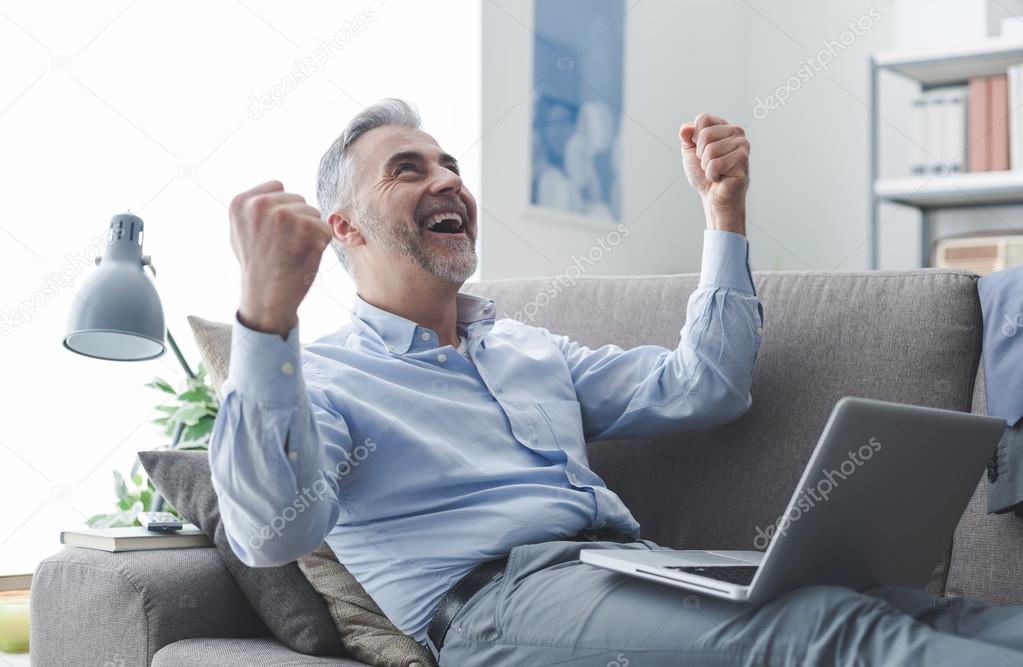Cheerful businessman with raised fists