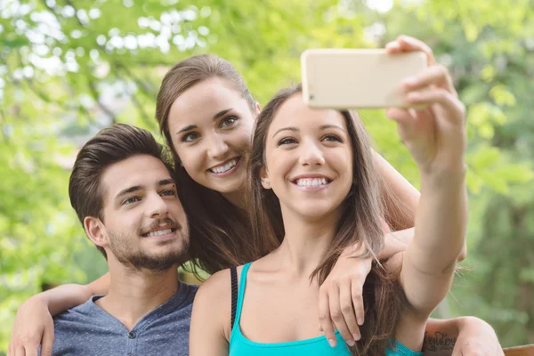 Adolescenti allegri al parco scattare selfie — Foto Stock