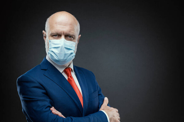 Corporate businessman posing with a surgical mask, coronavirus covid-19 prevention