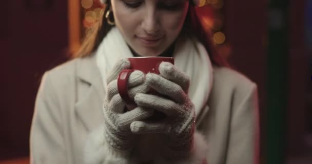 Young woman drinking from a mug. — Stock Video