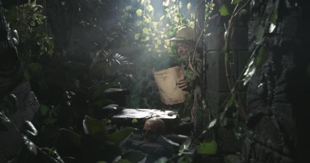Explorer checking a map in the forest — Stock Footage Explorer checking a map in the forest Royalty Free Stock Footage