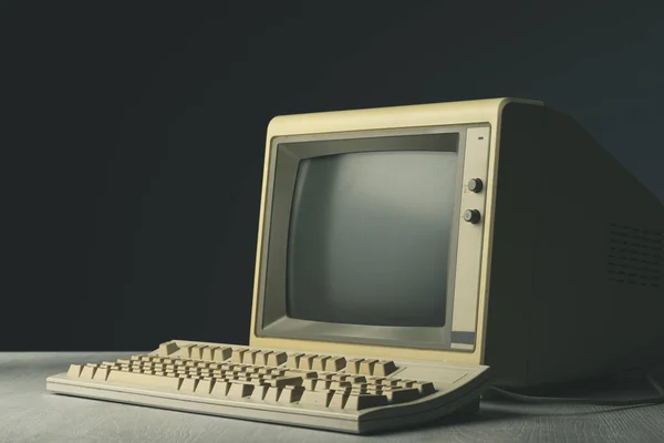 Vintage personal computer with keyboard on a desktop, outdated electronics concept