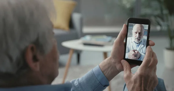 Senior Man Video Calling His Online Doctor Home Telemedicine Concept — Stock Photo, Image