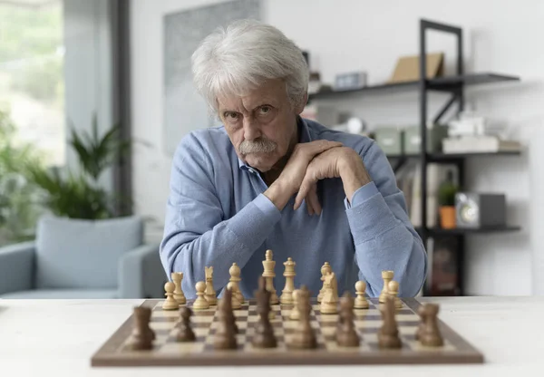 Confident Senior Man Playing Chess Home Looking Camera — Stock Photo, Image